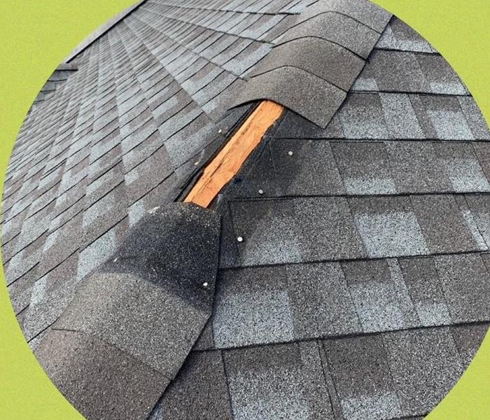 A photo showing missing shingles off a roof.